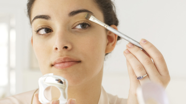 Woman applying makeup