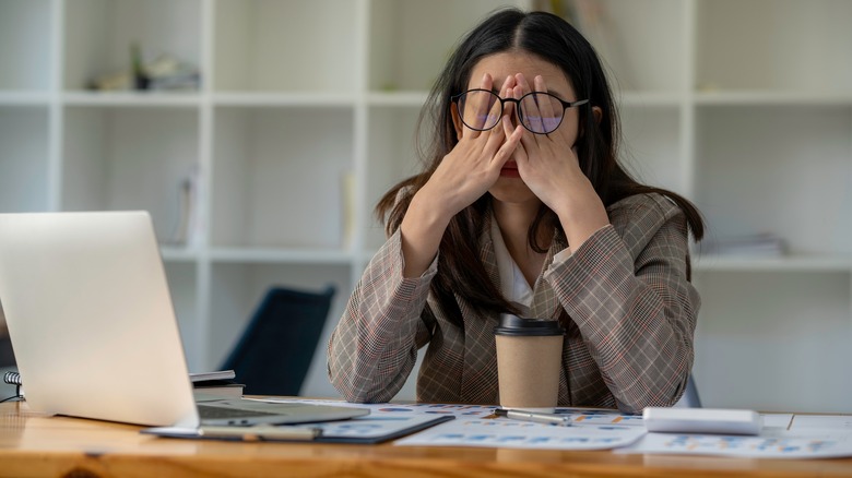 A woman sitting at her desk