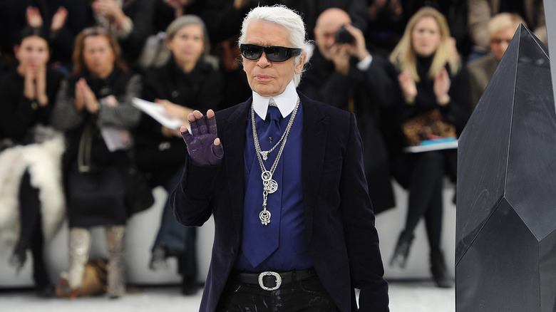 Karl Lagerfeld walking the runway waving