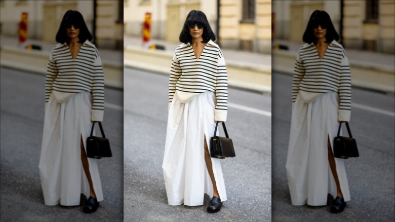 Woman wearing white maxi skirt with slit