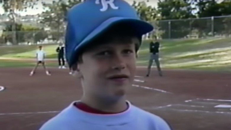 Young Tom Brady in a baseball cap