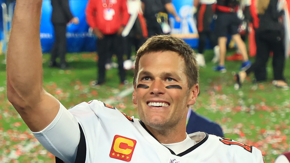 Tom Brady hand up in celebration after winning Super Bowl in Buccaneers uniform