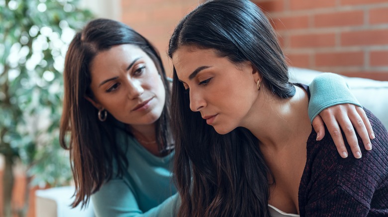 sad women comforting each other