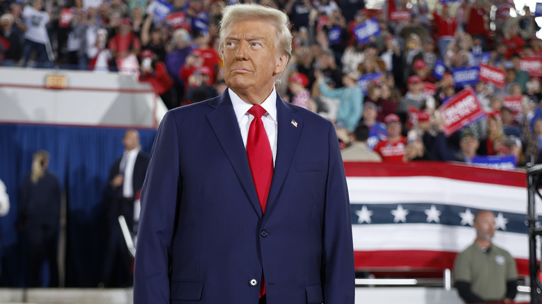 Donald Trump standing on stage at a political rally