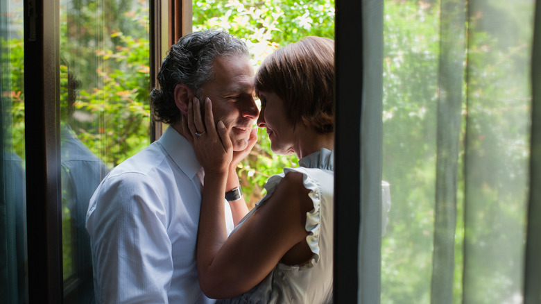 Happy couple by window