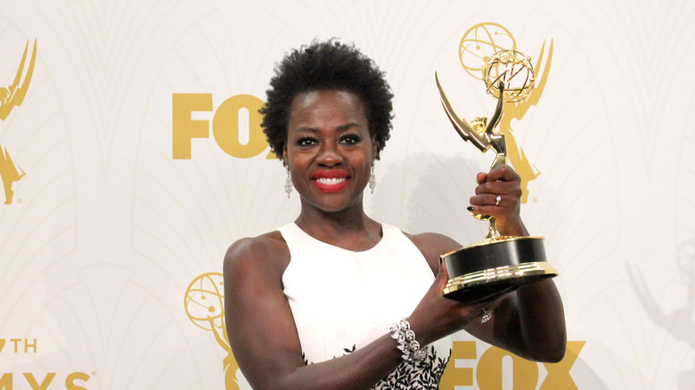 Viola Davis holding up her Emmy