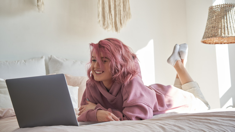 Woman watching TV from laptop