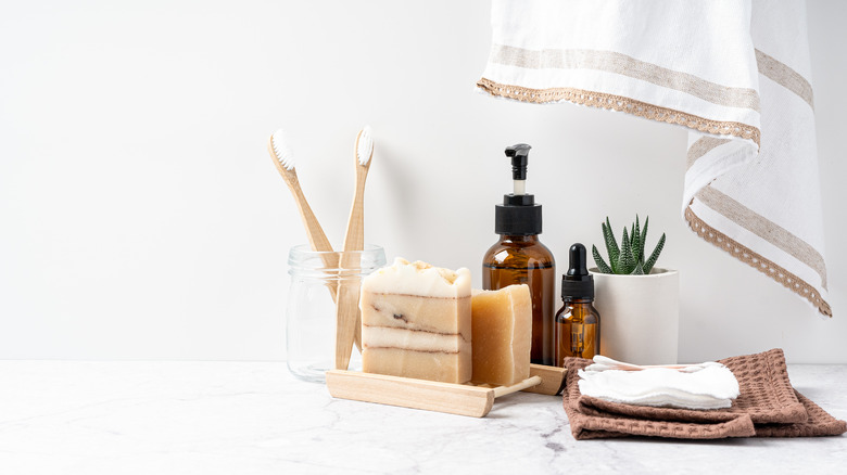 Bathroom counter with toothbrush, soap, and skincare items