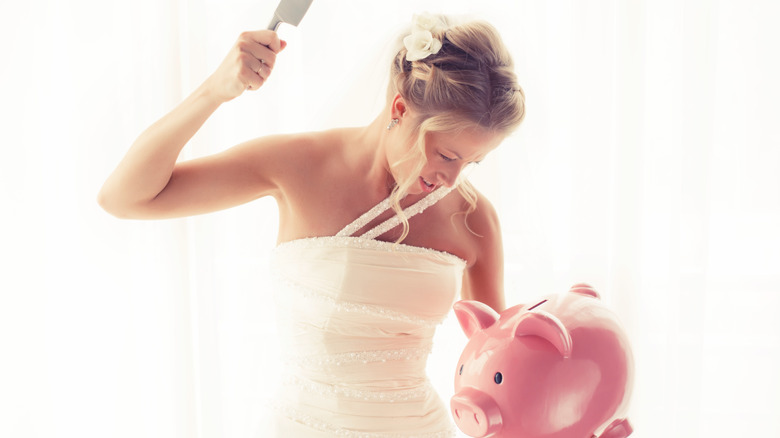 Bride breaking piggybank