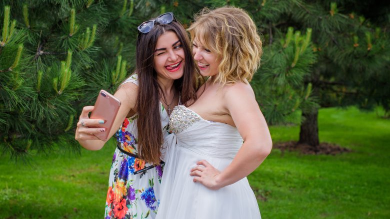 bride and guest taking selfie
