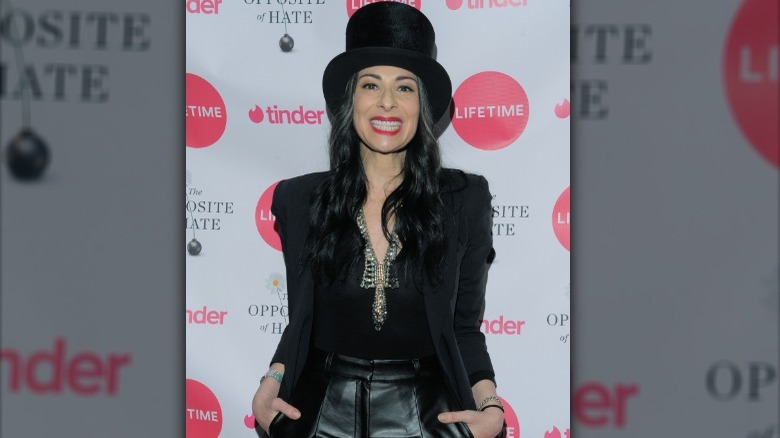 Stacy London in tophat and black outfit 