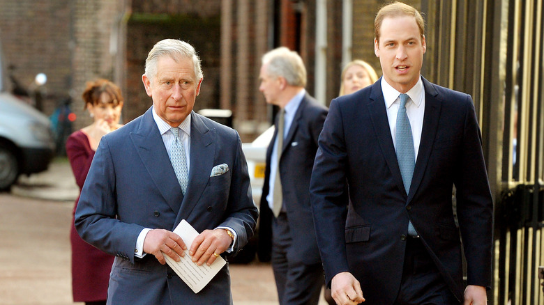 Princes Charles and William walking outside together