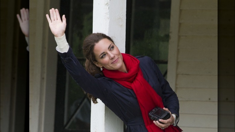 Catherine Middleton waving with camera in her hand