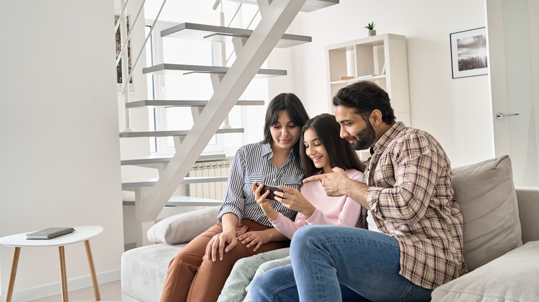 Family playing near their TV Screen