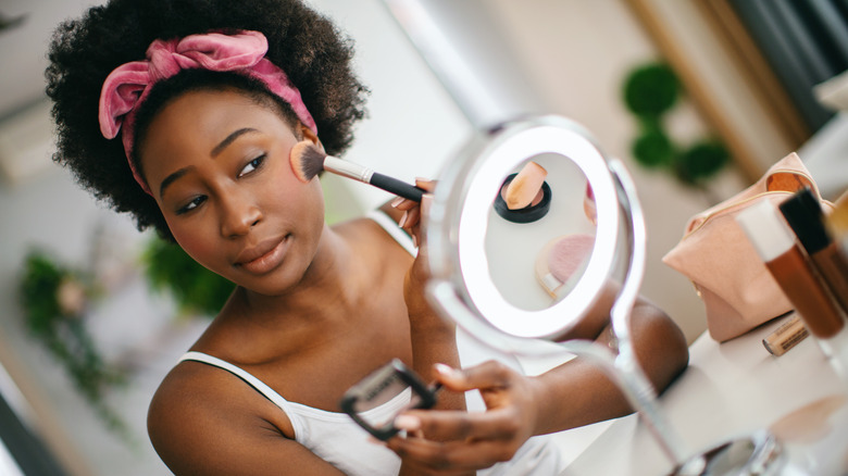 Woman putting on subtle blush