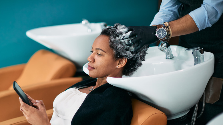 Woman getting hair treatment at the salon