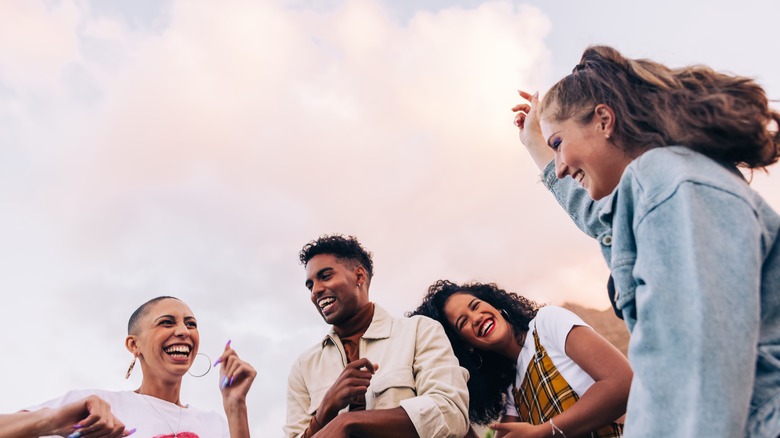 Four friends laughing together