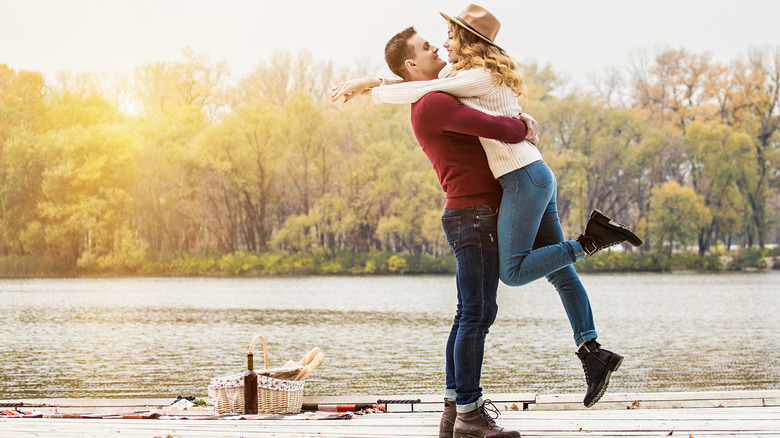 Couple hugging on bridge