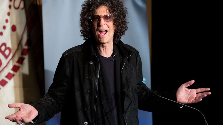 Howard Stern gestures onstage