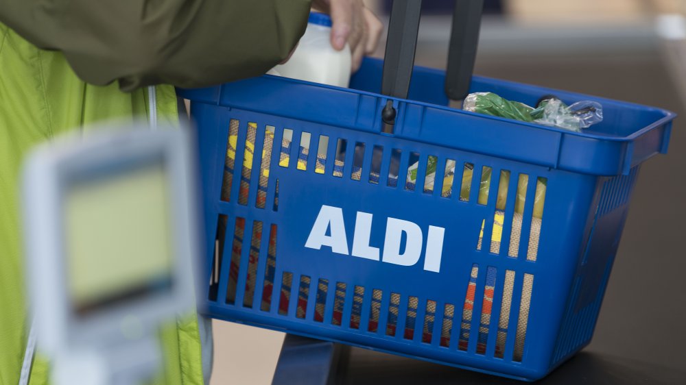 A customer holding an Aldi basket