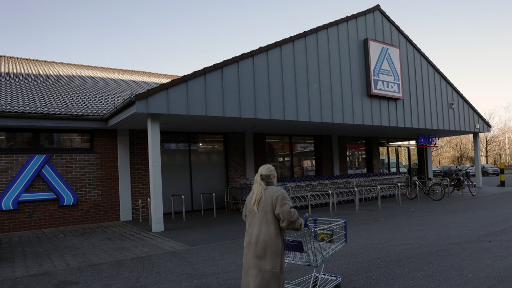 A woman with a cart outside of Aldi