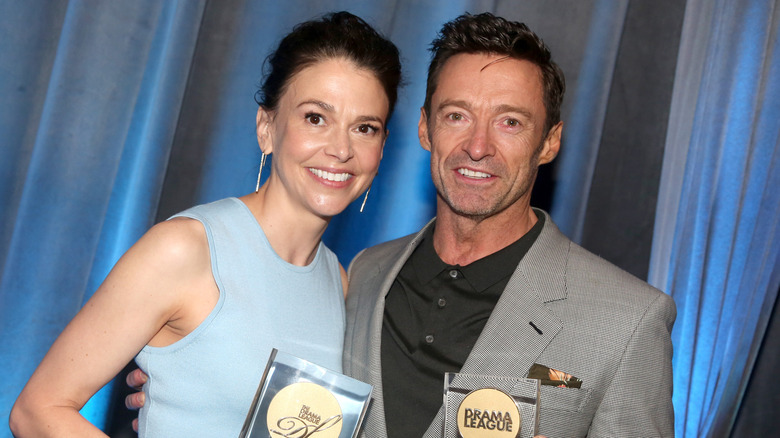 Sutton Foster and Hugh Jackman holding awards