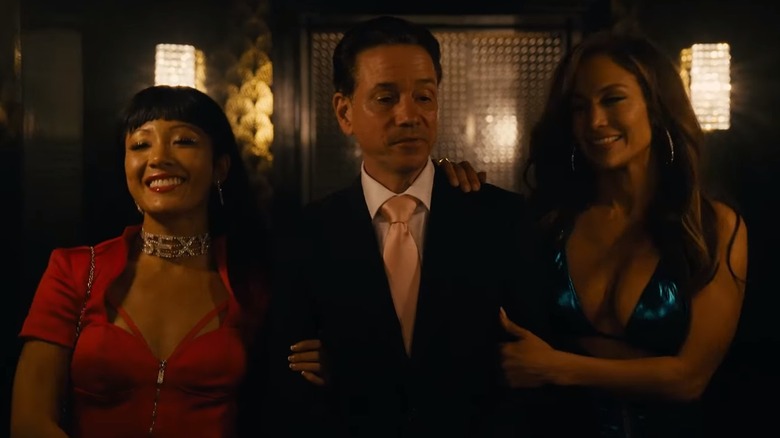 Constance Wu and J-Lo with a man in Hustlers