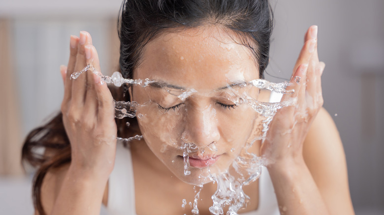 woman rinses washes face