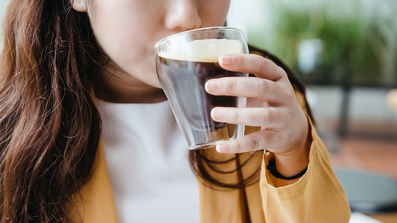 woman sipping cold brew coffee