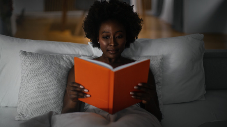 Woman reading in bed