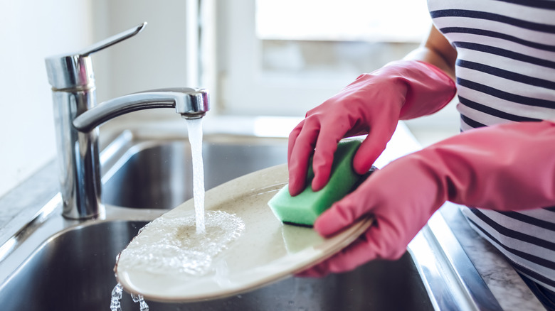 Doing dishes with rubber gloves