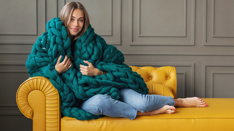 woman with cozy green blanket