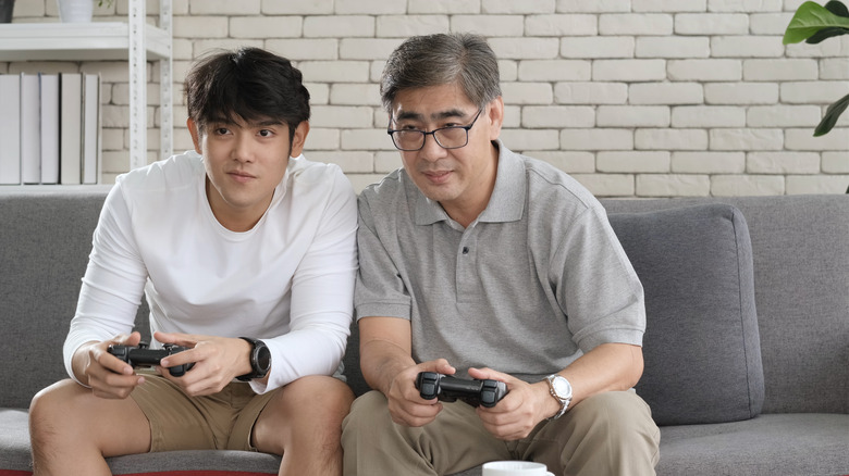 Father and son playing a video game together