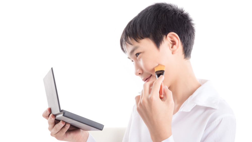 Boy using face powder