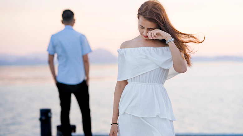 Unhappy couple on pier