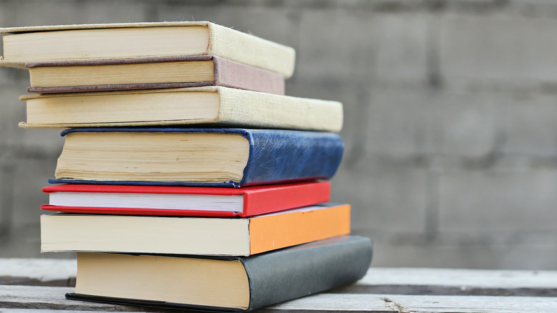 books stacked on a wooden table