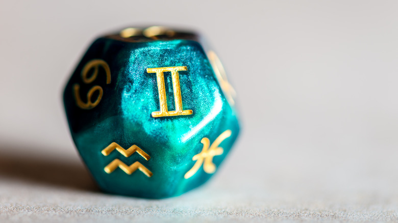 Zodiac signs on a die