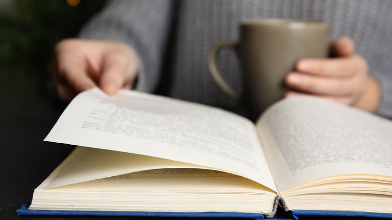 Woman reading a book with coffee 