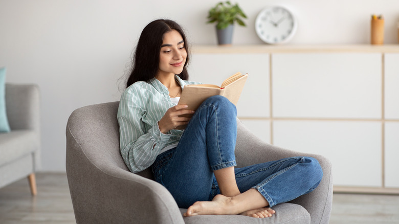 woman sitting in a chair reading