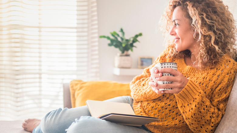 A woman relaxing with a book. 