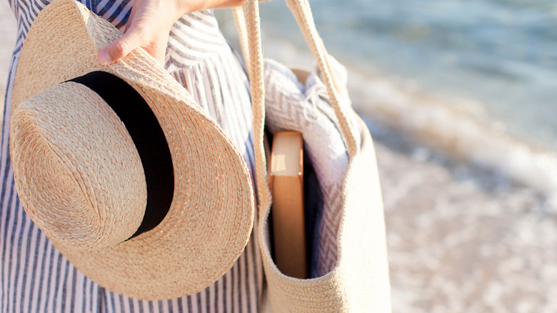 book in a tote bag on the beach