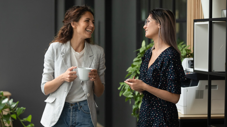 Two women smiling in office