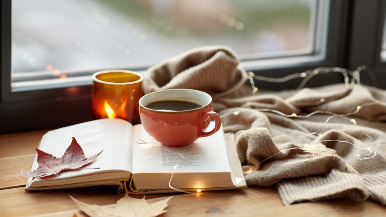 book with mug on top