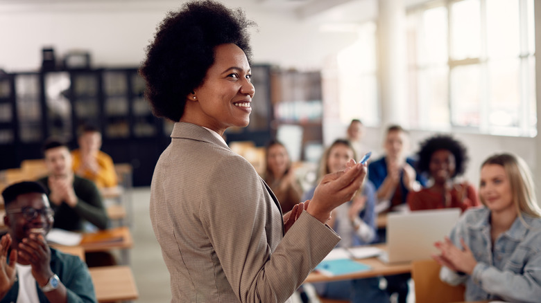 Professor smiling in front of her class