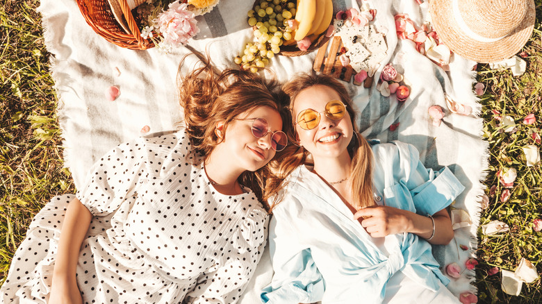 Two friends laughing having a picnic