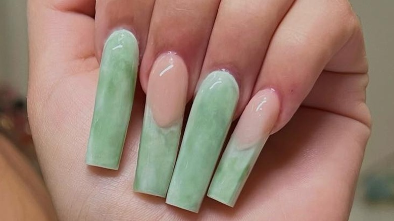 Hand with jade green nail art