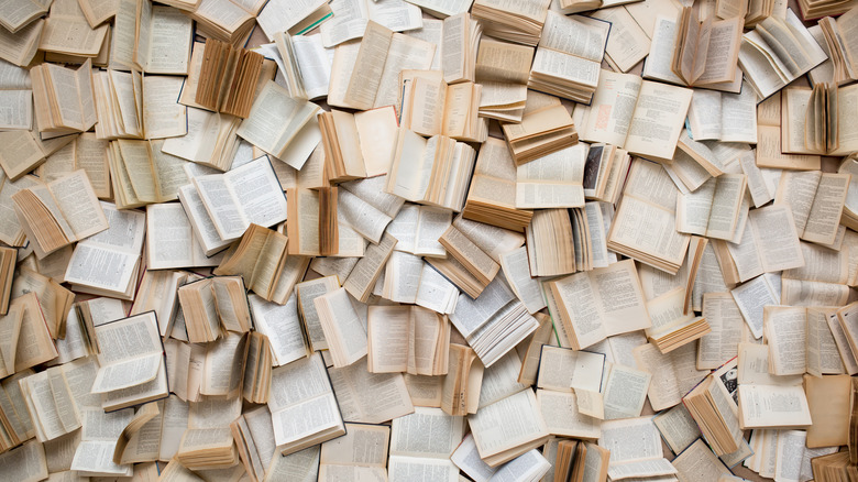 Overhead view of hundreds of books laid open