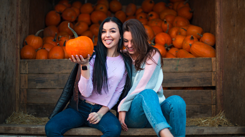 friends posing at pumpkin patch