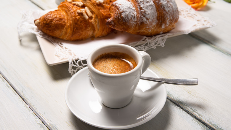 Espresso shot with two croissants