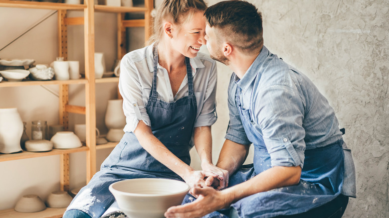 Couple making ceramics together